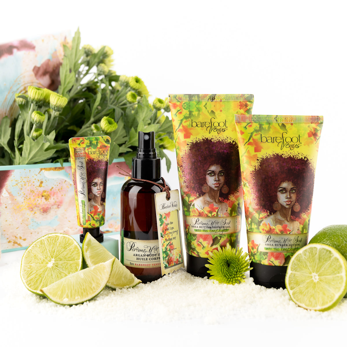 A collection of Barefoot Venus Into the Limelight products displayed alongside limes, flowers and bath soak.