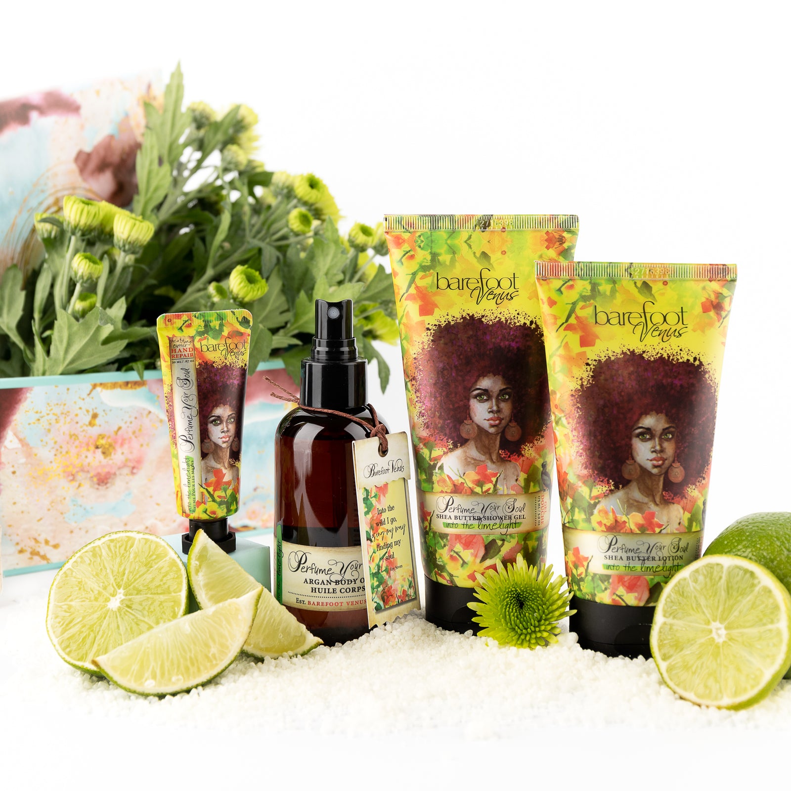 A collection of Barefoot Venus Into the Limelight products displayed alongside limes, flowers and bath soak.