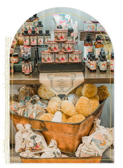Barefoot Venus Ruby Red products on display along with sea sponge tin all surrounded by a decorative frame.