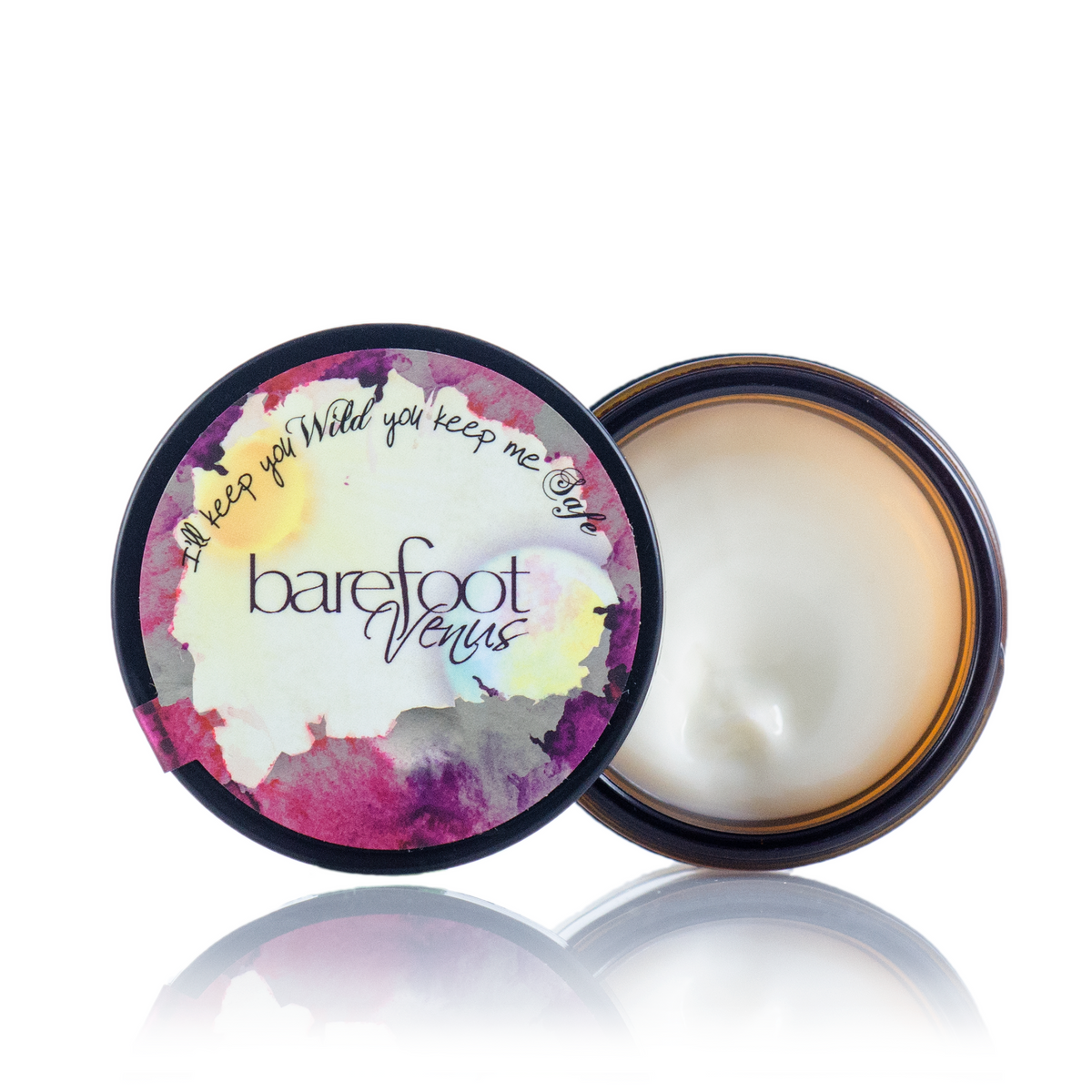 A jar of Barefoot Venus Black Coconut instant hand repair opened with a floral design on the lid and product in the jar.