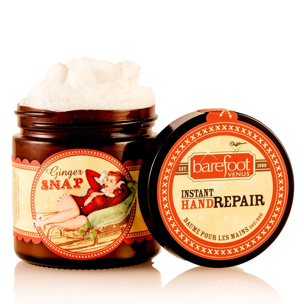 Jar of Barefoot Venus Ginger Snap instant hand repair with a woman in a red outfit lying in a toboggan design on the packaging on a white background.