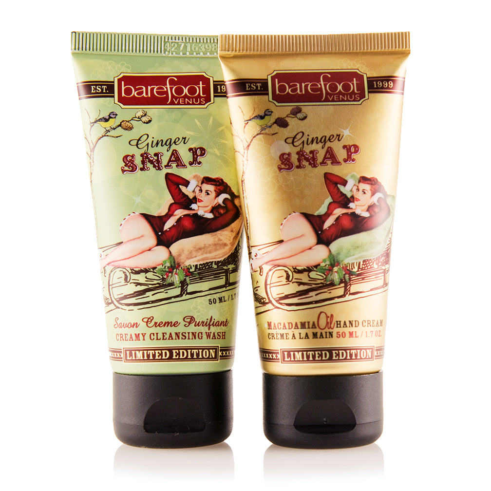 Two tubes of Barefoot Venus Ginger Snap creamy cleansing wash mini and hand cream with a woman in a red outfit lying in a toboggan design on the packaging on a white background.