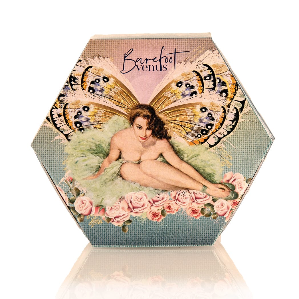 Barefoot Venus The Vanilla Effect bath bliss product featuring a woman with wings in a green dress sitting on a bed of flowers.