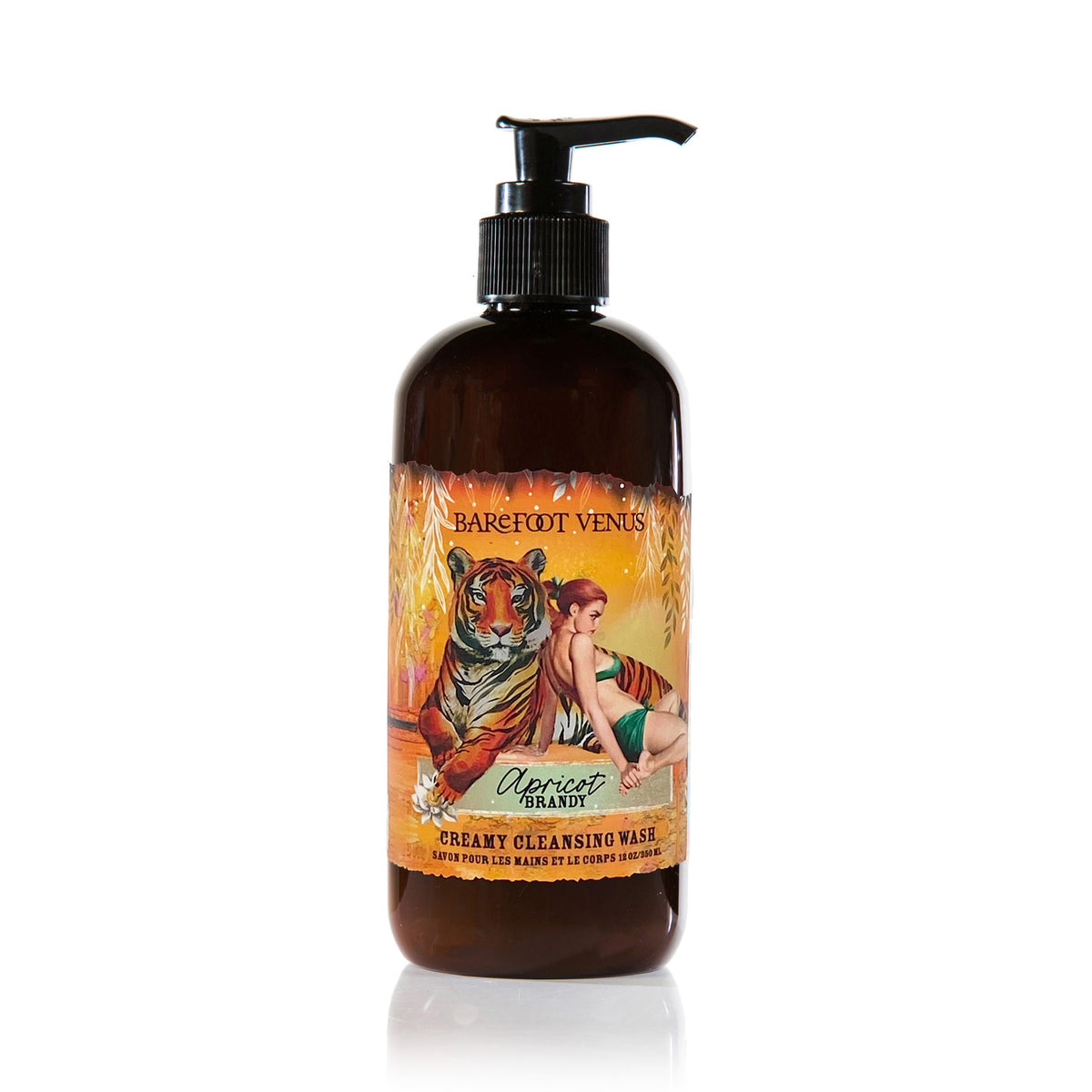 A pump bottle of Barefoot Venus Apricot Brandy creamy cleansing wash with a black lid and a design of a tiger and a woman in a green outfit on a white background.