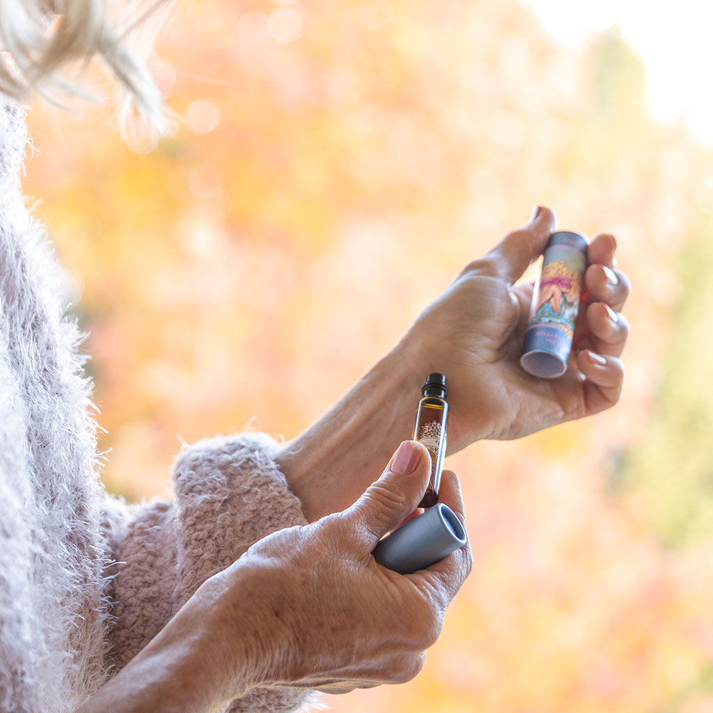 Person applying Barefoot Venus Coconut Kiss perfume oil onto wrist.