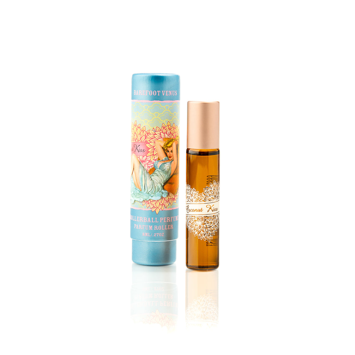 Packaging and bottle of Barefoot Venus Coconut Kiss perfume oil product featuring a woman in a blue dress with a floral background design on a white background.
