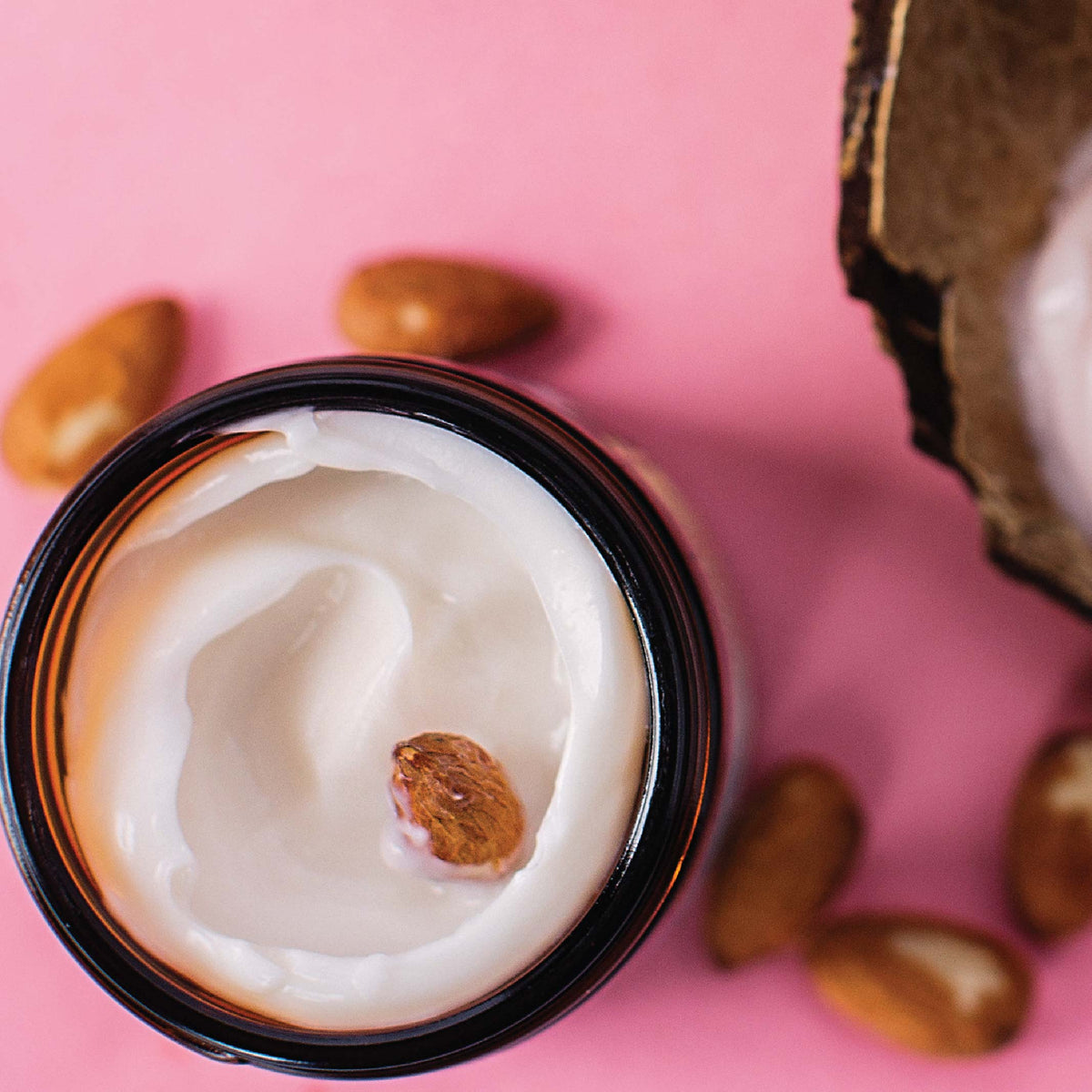 Birds eye view of a jar of Barefoot Venus instant hand repair opened on a pink background.