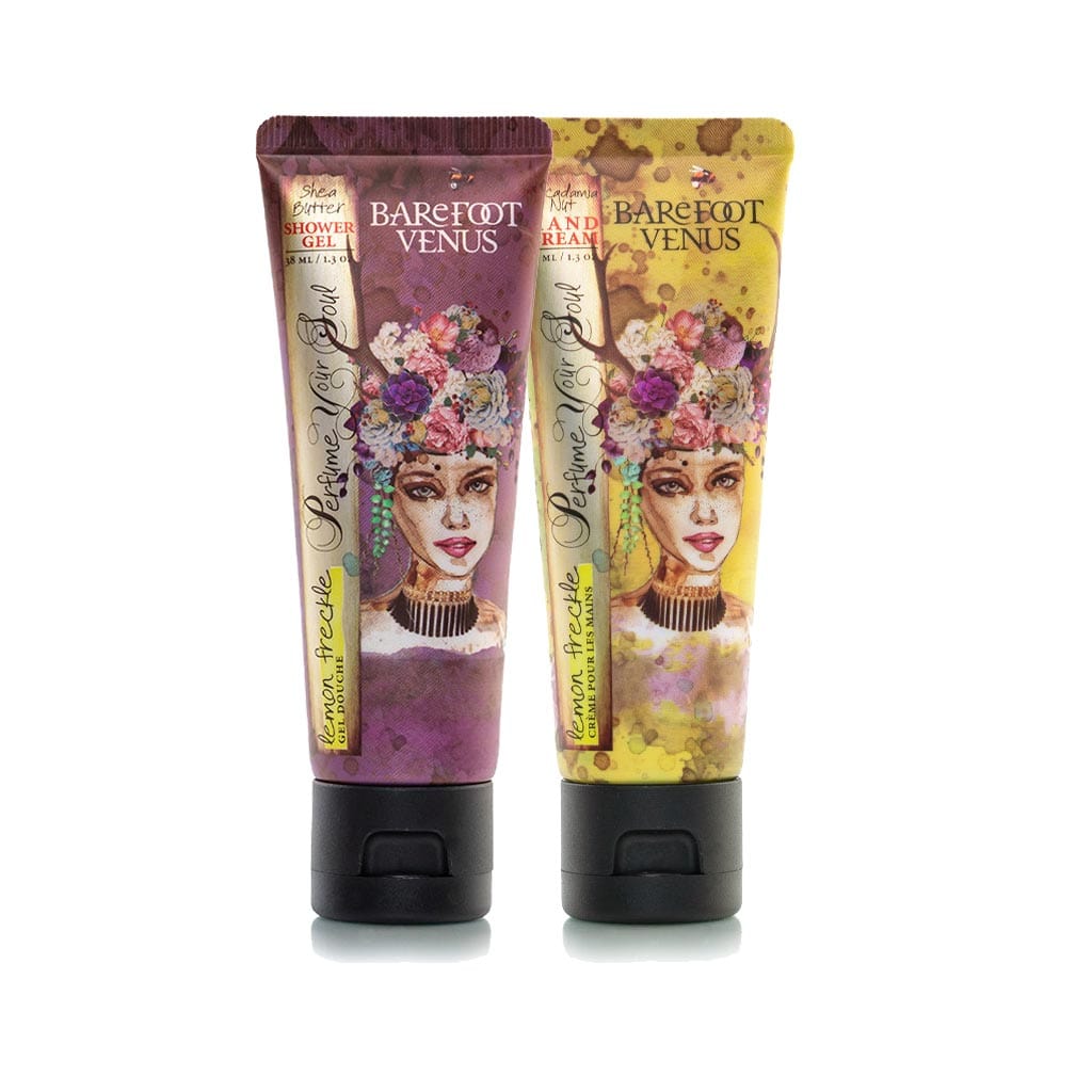 Two tubes of Barefoot Venus Coconut Kiss products featuring a woman in a blue dress with a floral background design with a white background.