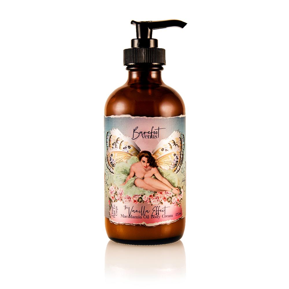 A pump bottle of The Vanilla Effect body cream with a label featuring a fairy illustration and text indicating the product name and scent.